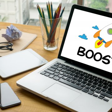 WinZip Registry Optimizer Overview registry cleaner laptop with boost text on screen smartphone glasses notebook on desk